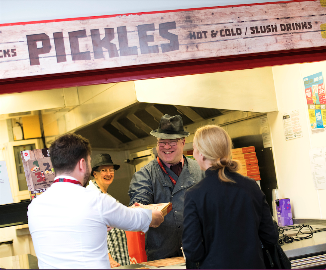 Myerscough College catering staff serving food to a member of staff